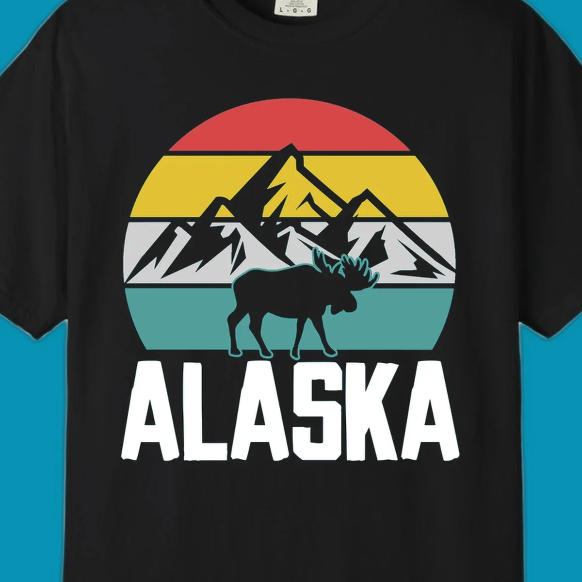 Moose mountain Alaska badge with white moose silhouette, snow peaks, and horizontal landscape stripes in red, gold, gray, and teal.