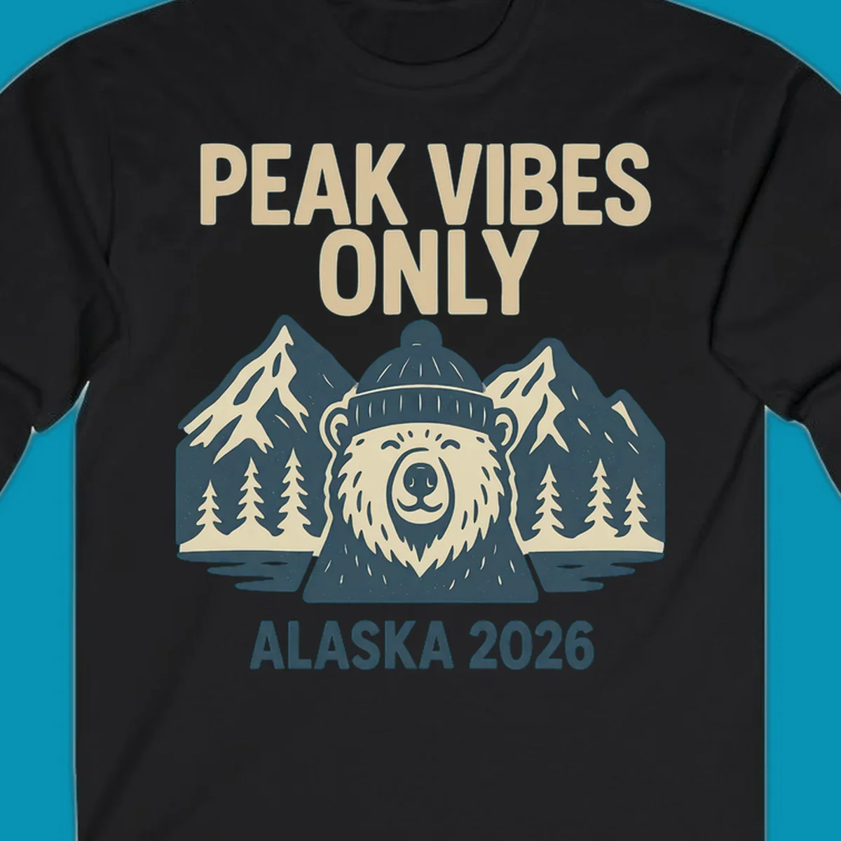 Vintage badge-style illustration of a smiling bear wearing a beanie with snow-capped mountains, evergreen trees, and water, text reads Peak Vibes Only Alaska 2026