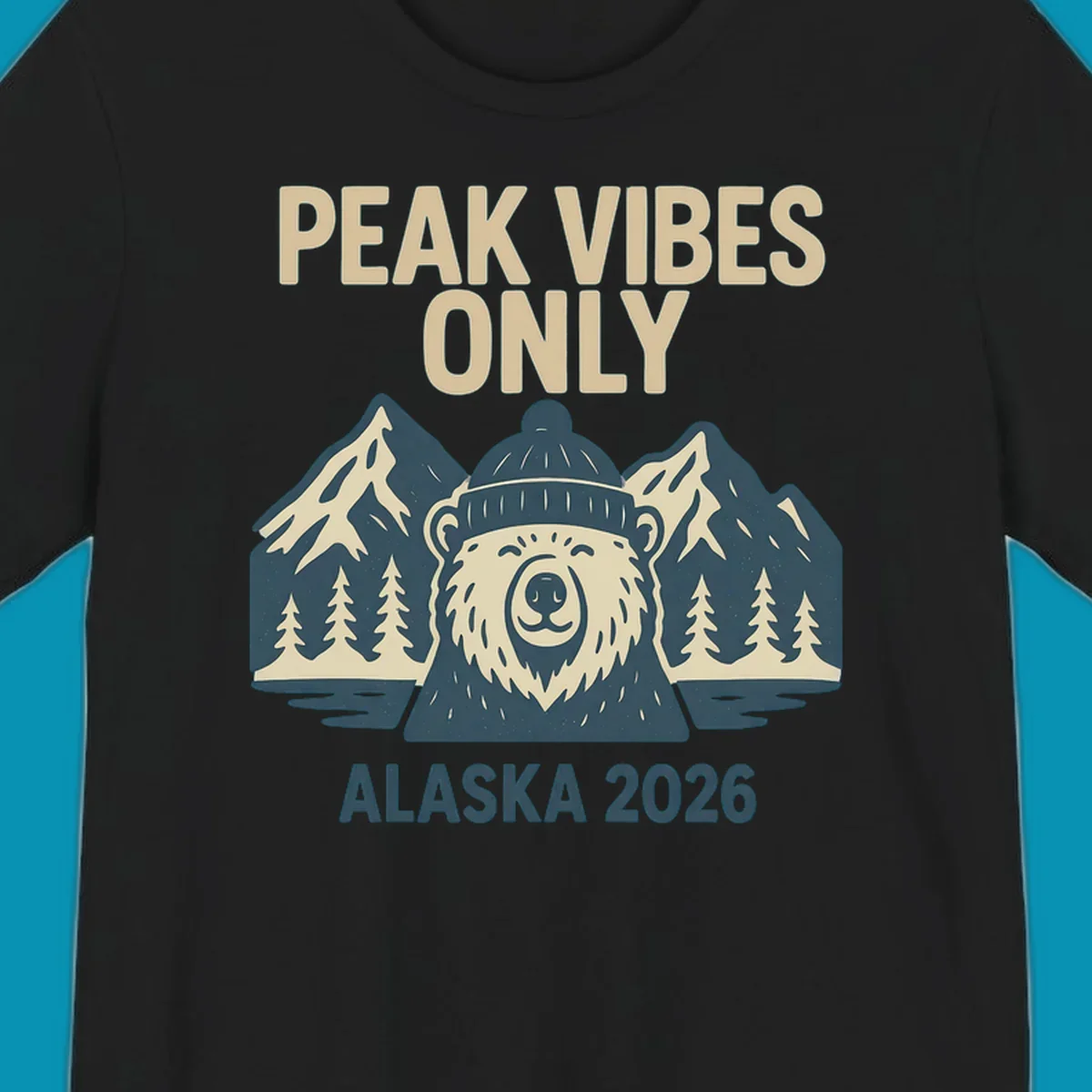 Vintage badge-style illustration of a smiling bear wearing a beanie with snow-capped mountains, evergreen trees, and water, text reads Peak Vibes Only Alaska 2026