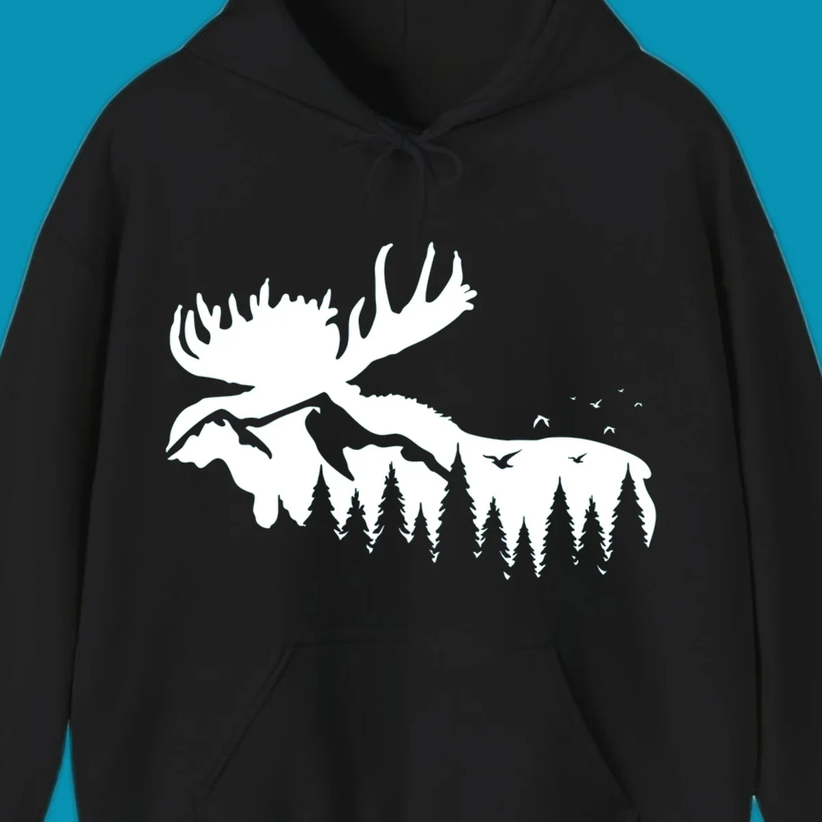 White silhouette of a moose with large antlers integrated into a forested mountain landscape with evergreen trees and flying birds against gray background.