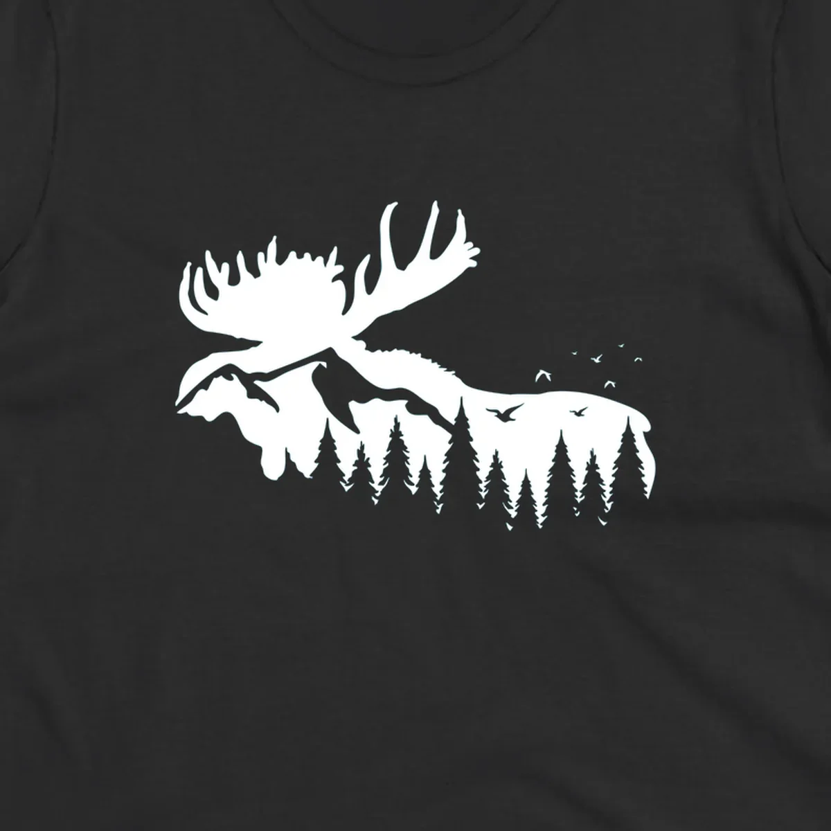 White silhouette of a moose with large antlers integrated into a forested mountain landscape with evergreen trees and flying birds against gray background.