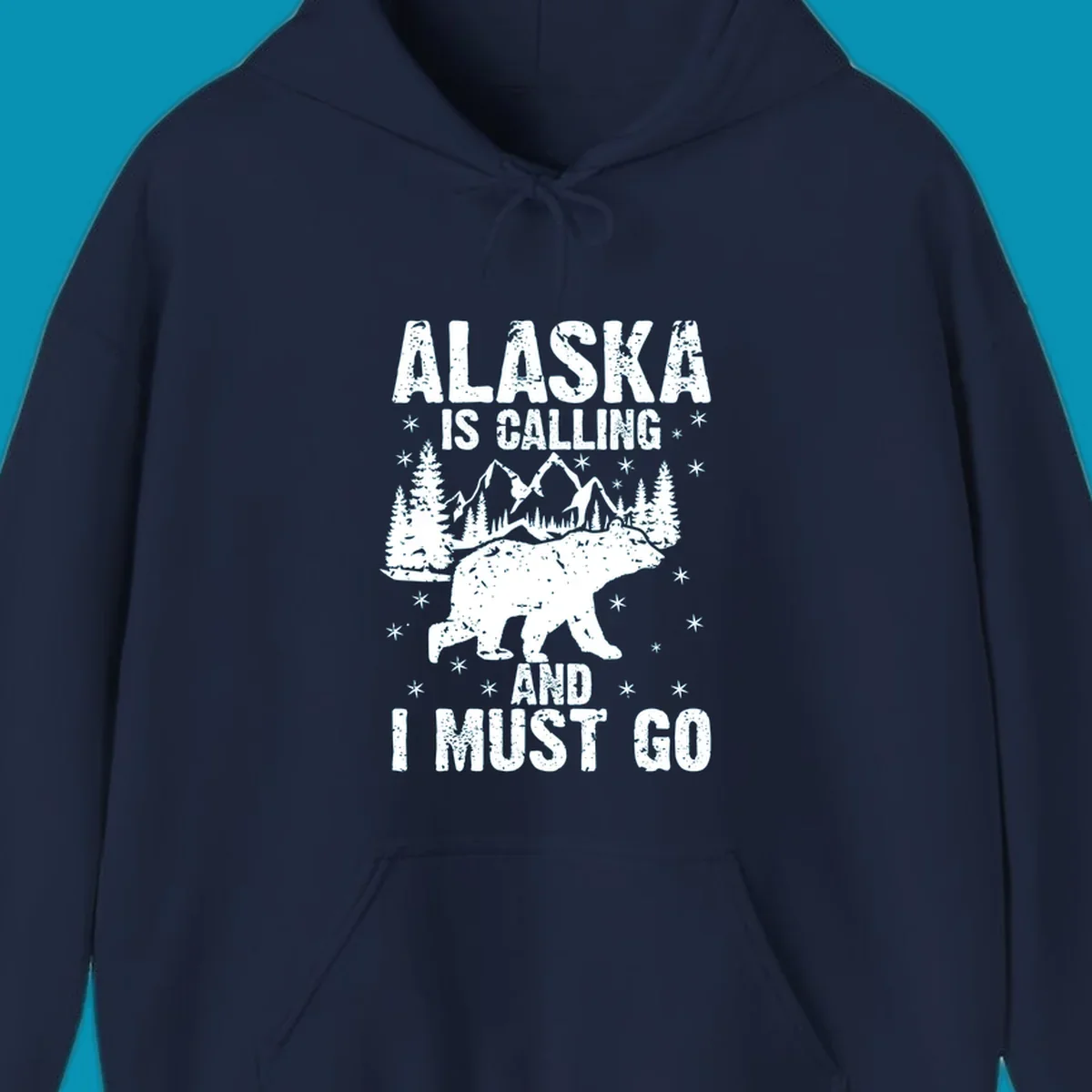 Distressed vintage design with polar bear in snowy mountains, text reads 'Alaska Is Calling And I Must Go'