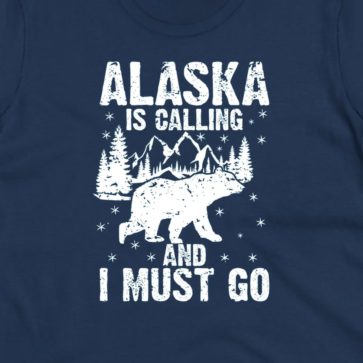 Distressed vintage design with polar bear in snowy mountains, text reads 'Alaska Is Calling And I Must Go'