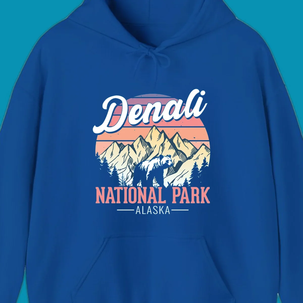 Retro vintage illustration of Denali National Park with snow-capped mountain peaks against a warm coral and peach sunset gradient background with text.