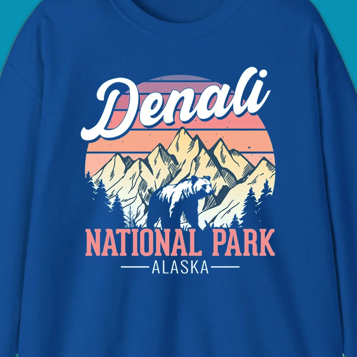 Retro vintage illustration of Denali National Park with snow-capped mountain peaks against a warm coral and peach sunset gradient background with text.