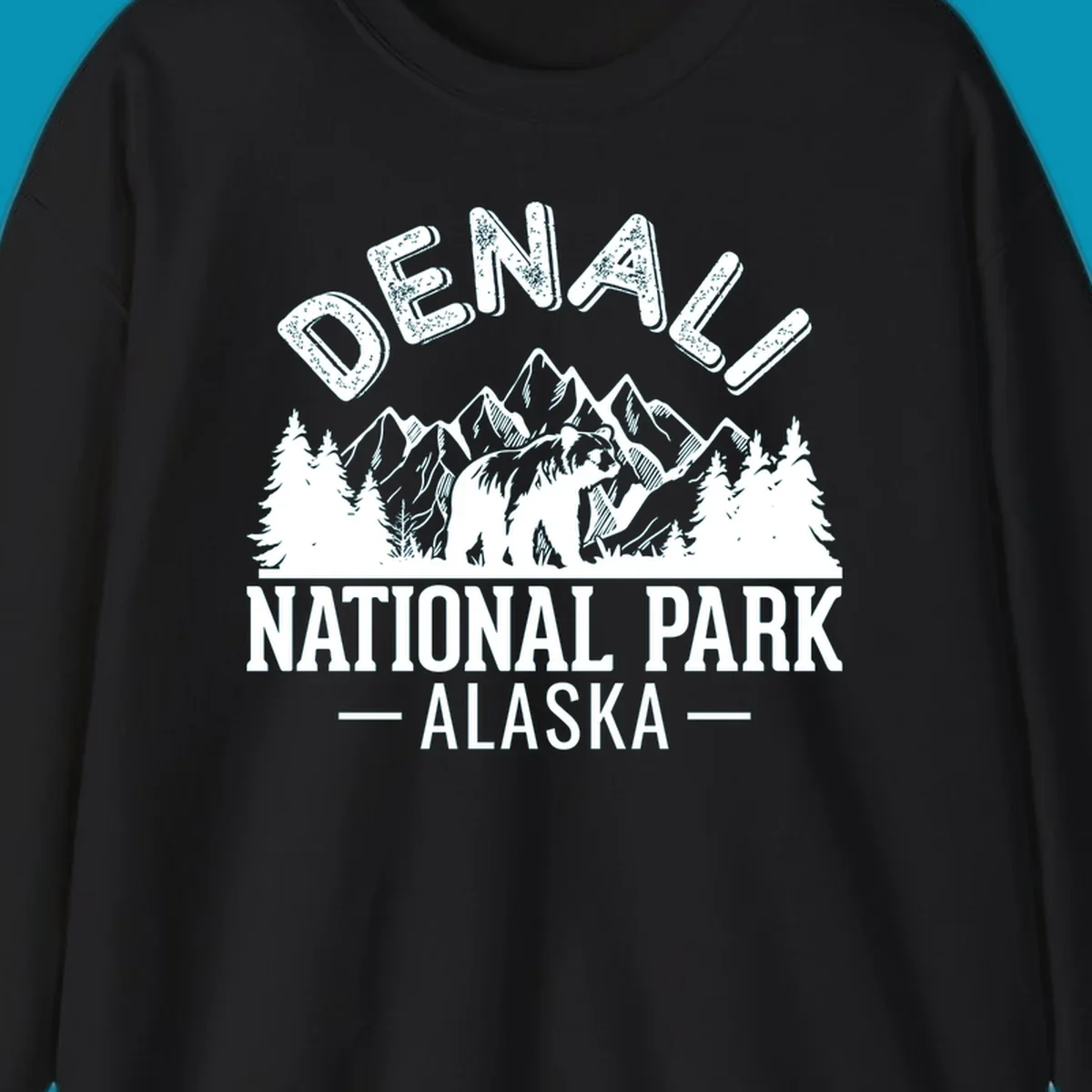Denali National Park bear design with mountains, evergreen trees, and distressed white text on gray background