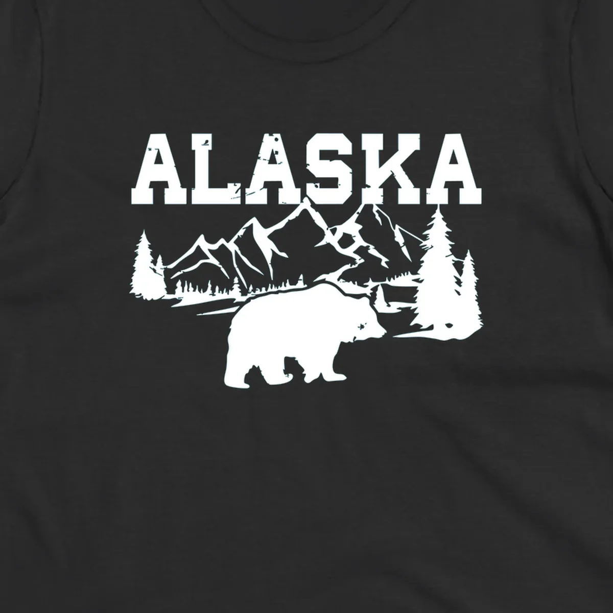 White silhouette illustration of a bear with mountains, evergreen trees, and river landscape under Alaska text on gray background
