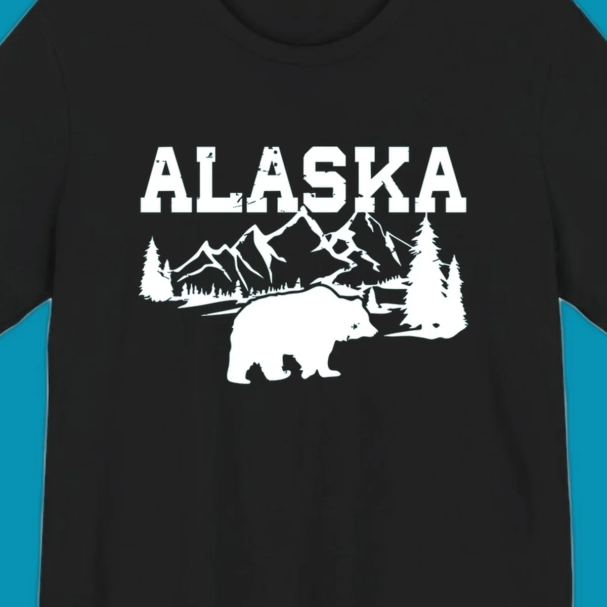 White silhouette illustration of a bear with mountains, evergreen trees, and river landscape under Alaska text on gray background