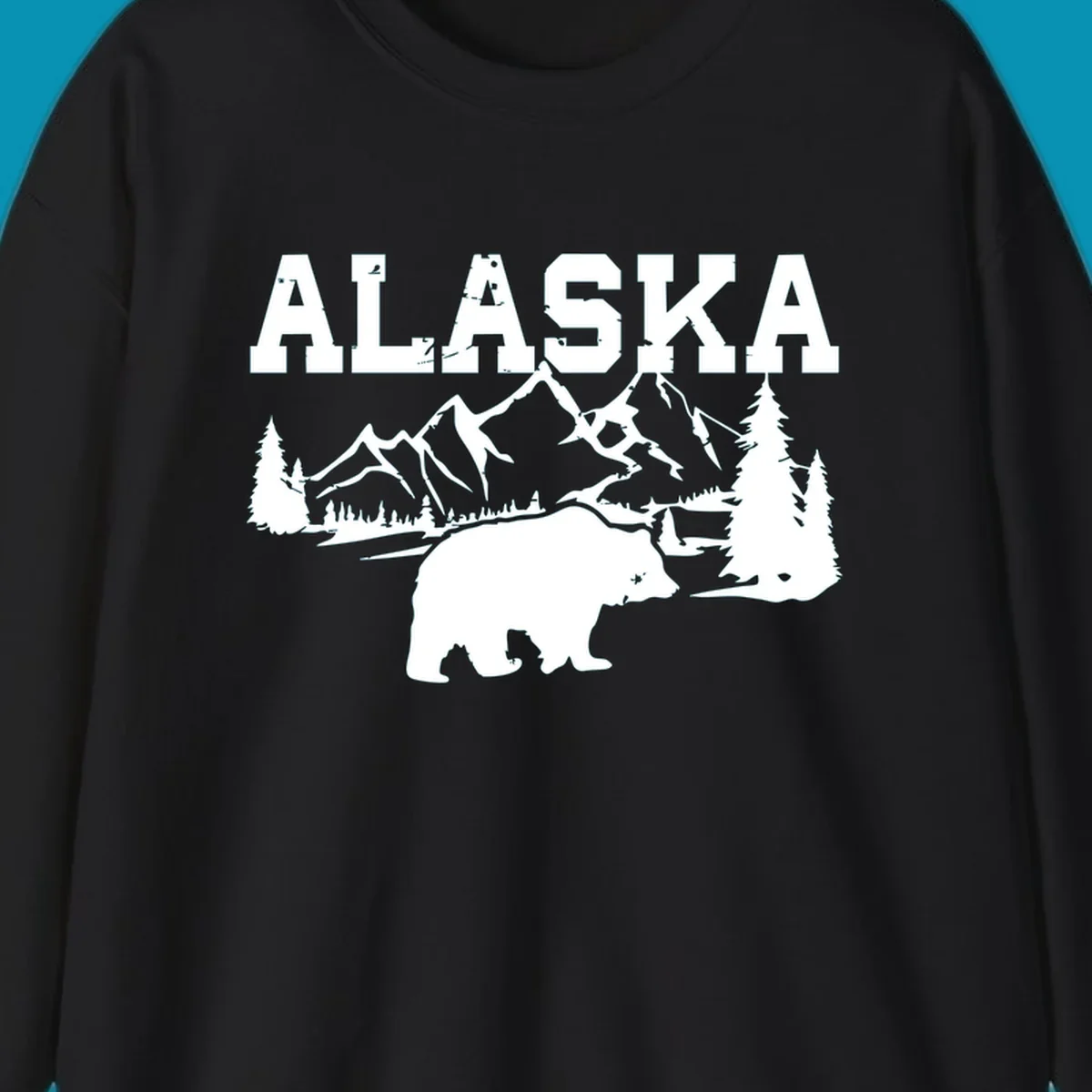White silhouette illustration of a bear with mountains, evergreen trees, and river landscape under Alaska text on gray background