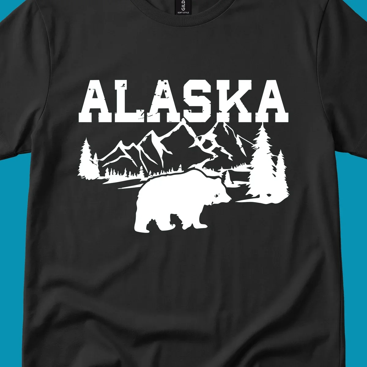 White silhouette illustration of a bear with mountains, evergreen trees, and river landscape under Alaska text on gray background