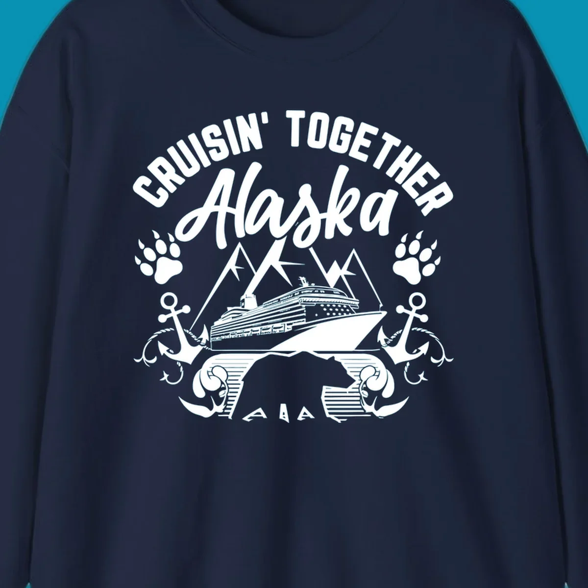 White nautical design on gray background featuring cruise ship between mountains with paw prints and anchors, text reads 'Cruisin' Together Alaska'