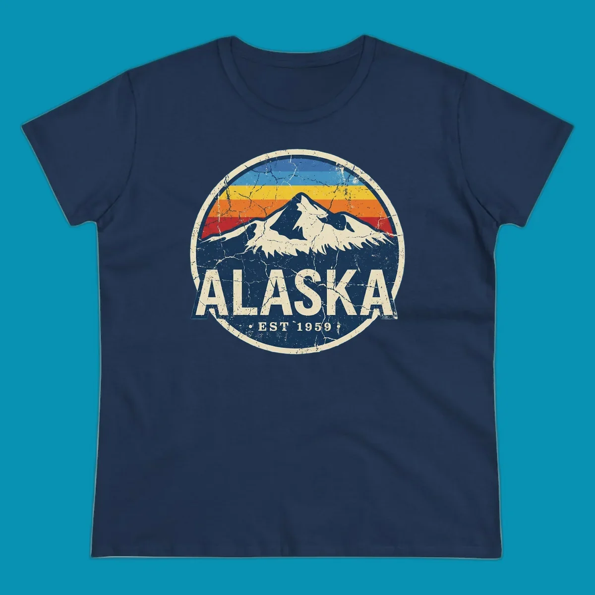 Vintage circular badge with snow-capped Alaska mountain, retro rainbow stripes, and distressed cream border featuring 'ALASKA EST 1959' text