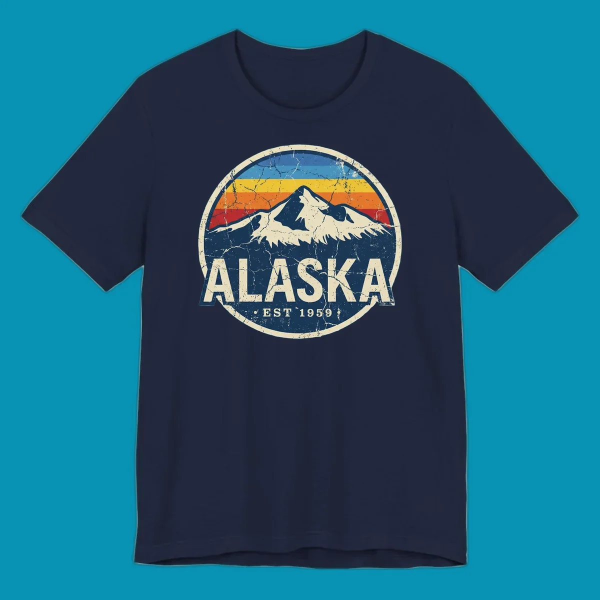 Vintage circular badge with snow-capped Alaska mountain, retro rainbow stripes, and distressed cream border featuring 'ALASKA EST 1959' text