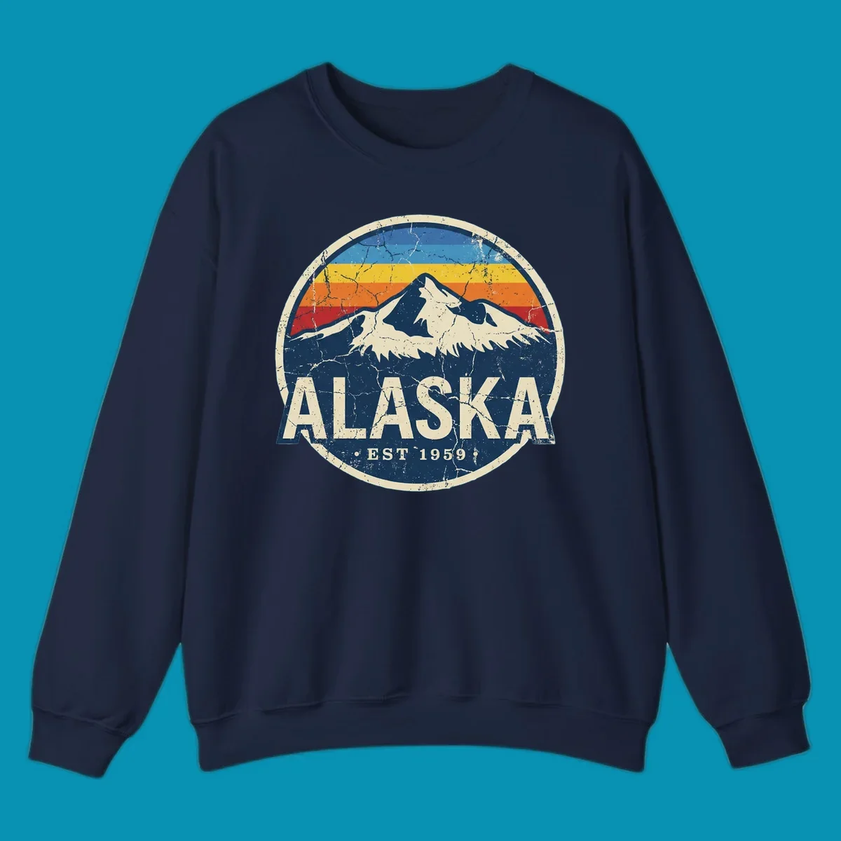 Vintage circular badge with snow-capped Alaska mountain, retro rainbow stripes, and distressed cream border featuring 'ALASKA EST 1959' text
