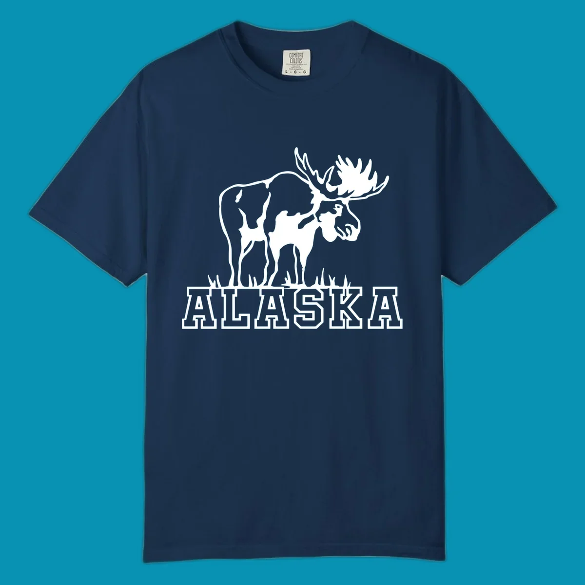 White silhouette of a majestic moose with large antlers standing with grass below and ALASKA text, moose-alaska-silhouette design