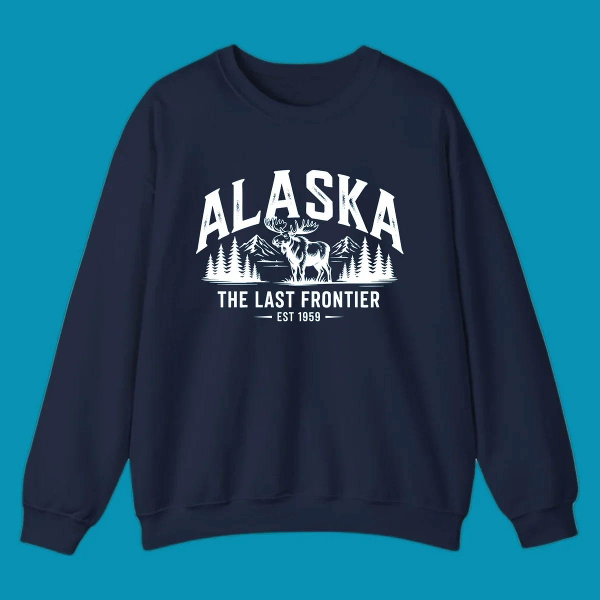 A white alaska-moose-frontier-scenic graphic showing a moose standing in front of mountains and pine trees.