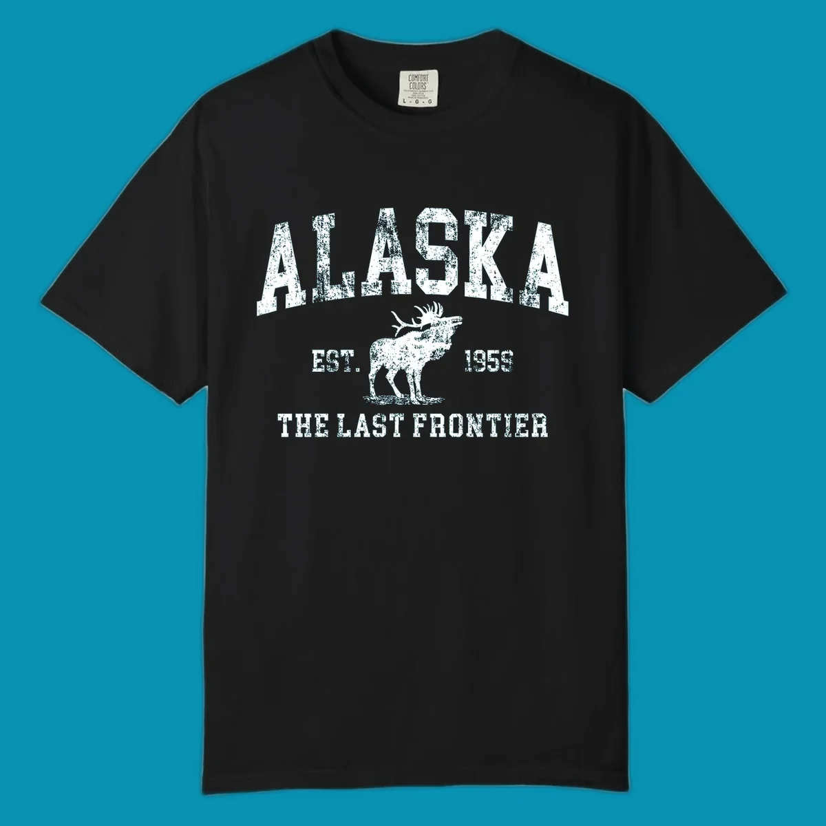 Distressed white design featuring a moose and the text ALASKA THE LAST FRONTIER.
