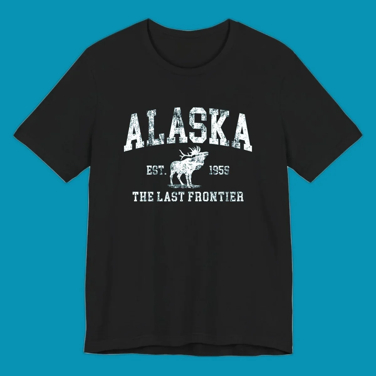 Distressed white design featuring a moose and the text ALASKA THE LAST FRONTIER.