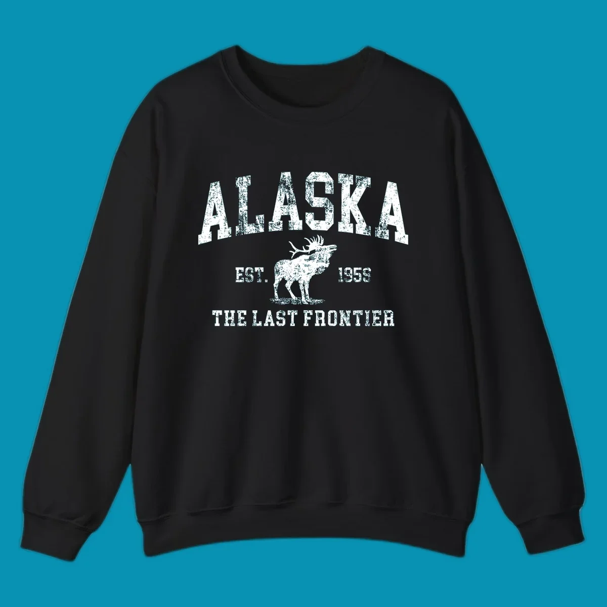 Distressed white design featuring a moose and the text ALASKA THE LAST FRONTIER.