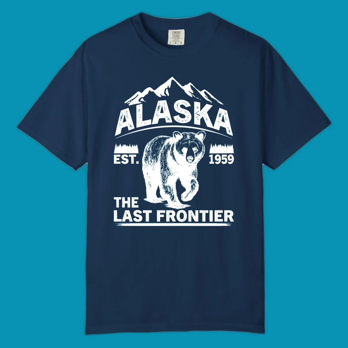 White graphic of a walking grizzly bear under mountain peaks with alaska-grizzly-frontier-mountains text.