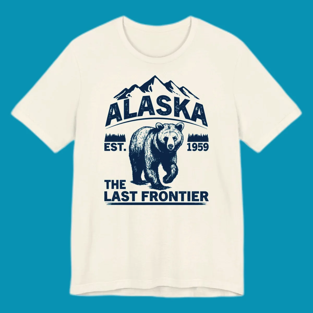 White graphic of a walking grizzly bear under mountain peaks with alaska-grizzly-frontier-mountains text.