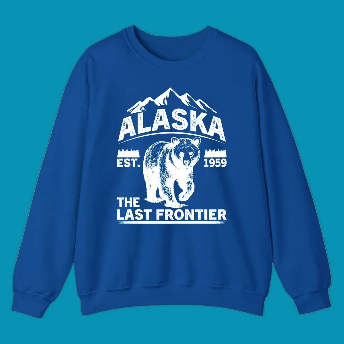 White graphic of a walking grizzly bear under mountain peaks with alaska-grizzly-frontier-mountains text.