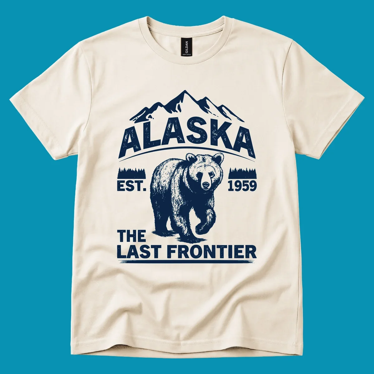 White graphic of a walking grizzly bear under mountain peaks with alaska-grizzly-frontier-mountains text.