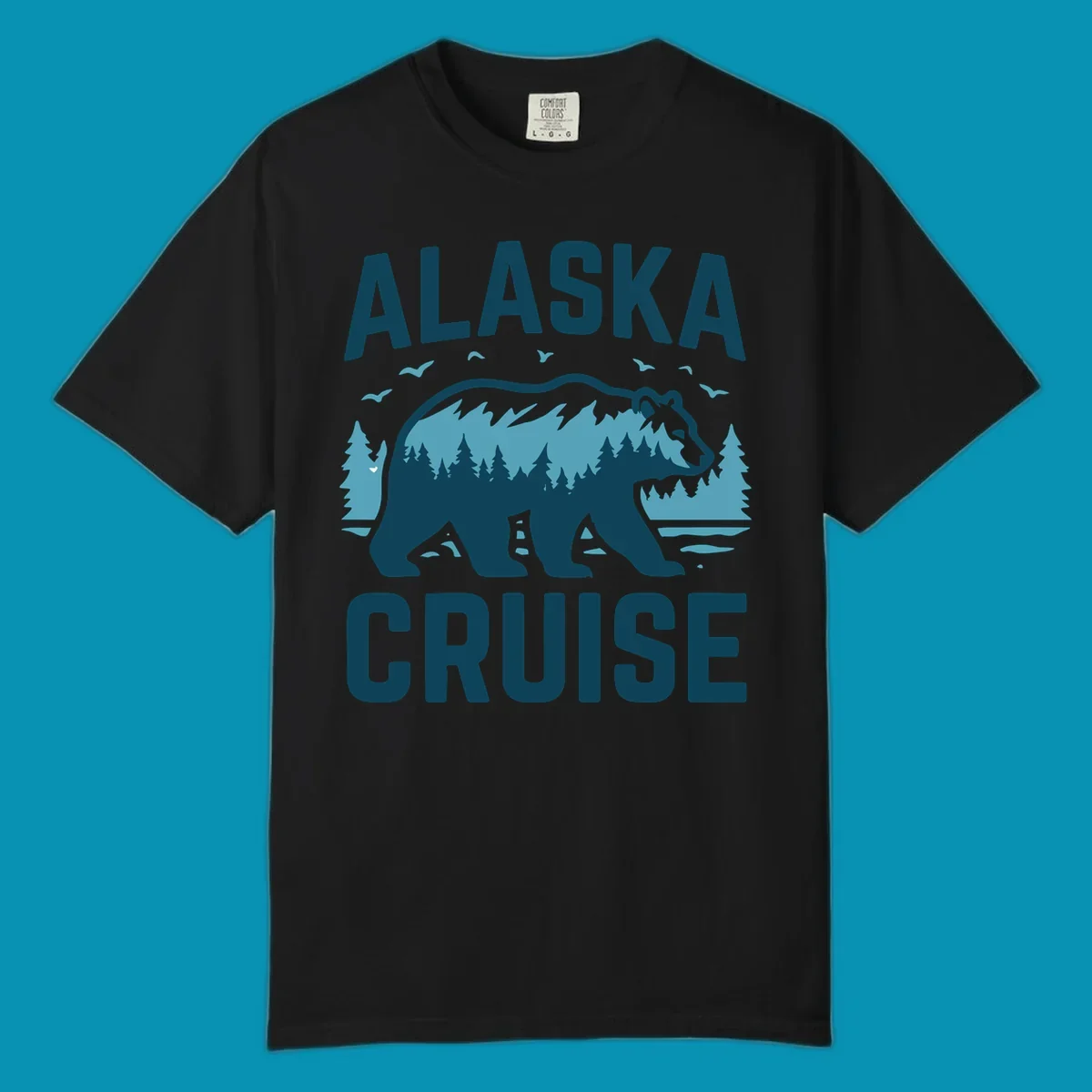 An illustrated design with 'ALASKA' and 'CRUISE' text, featuring a walking alaska-bear-mountain-silhouette filled with a forest and mountain landscape, surrounded by trees, birds, and water.