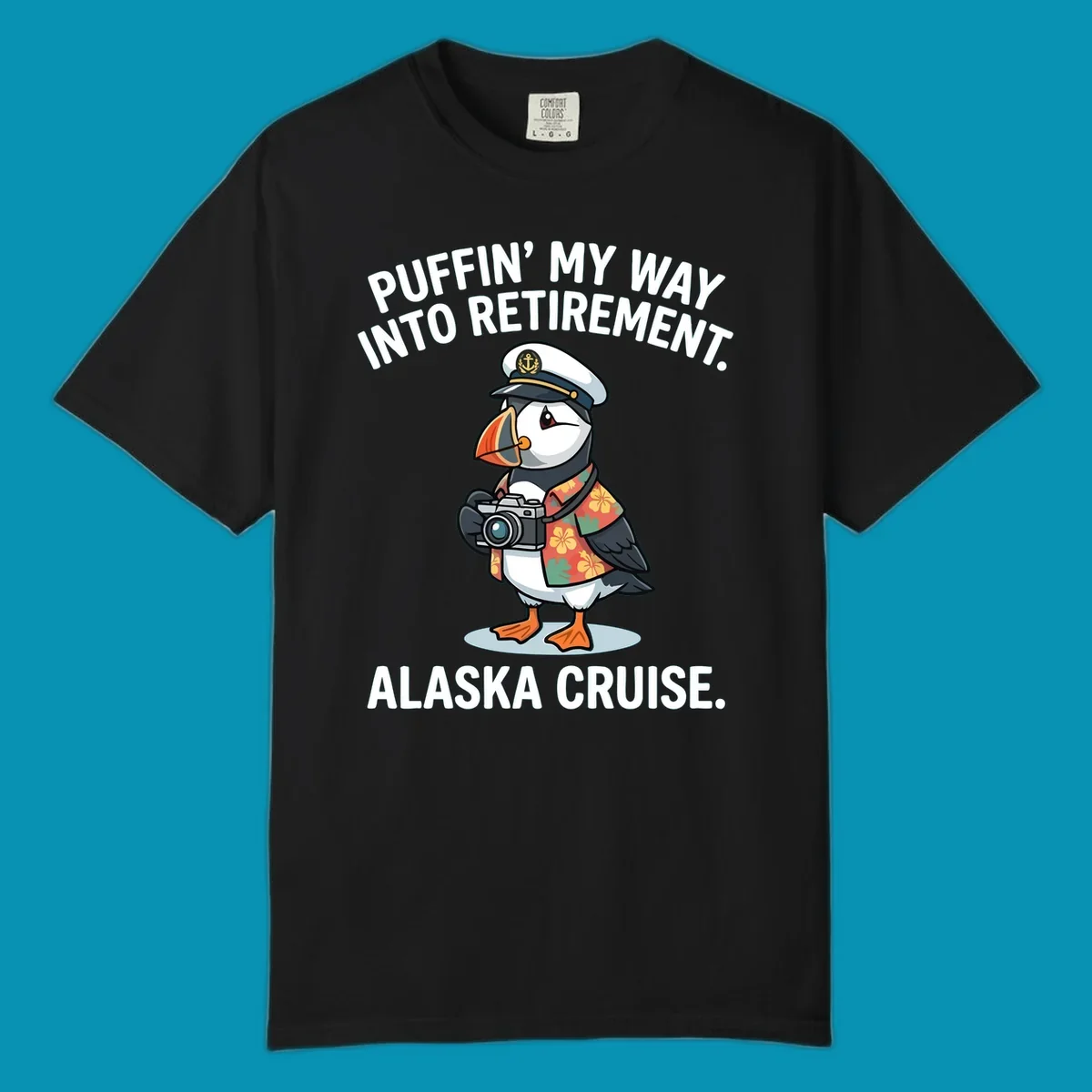 A cartoon puffin wearing a captain's hat and Hawaiian shirt holds a camera, with text 'PUFFIN' INTO MY RETIREMENT. ALASKA CRUISE.' for a puffin-into-retirement-cruise.