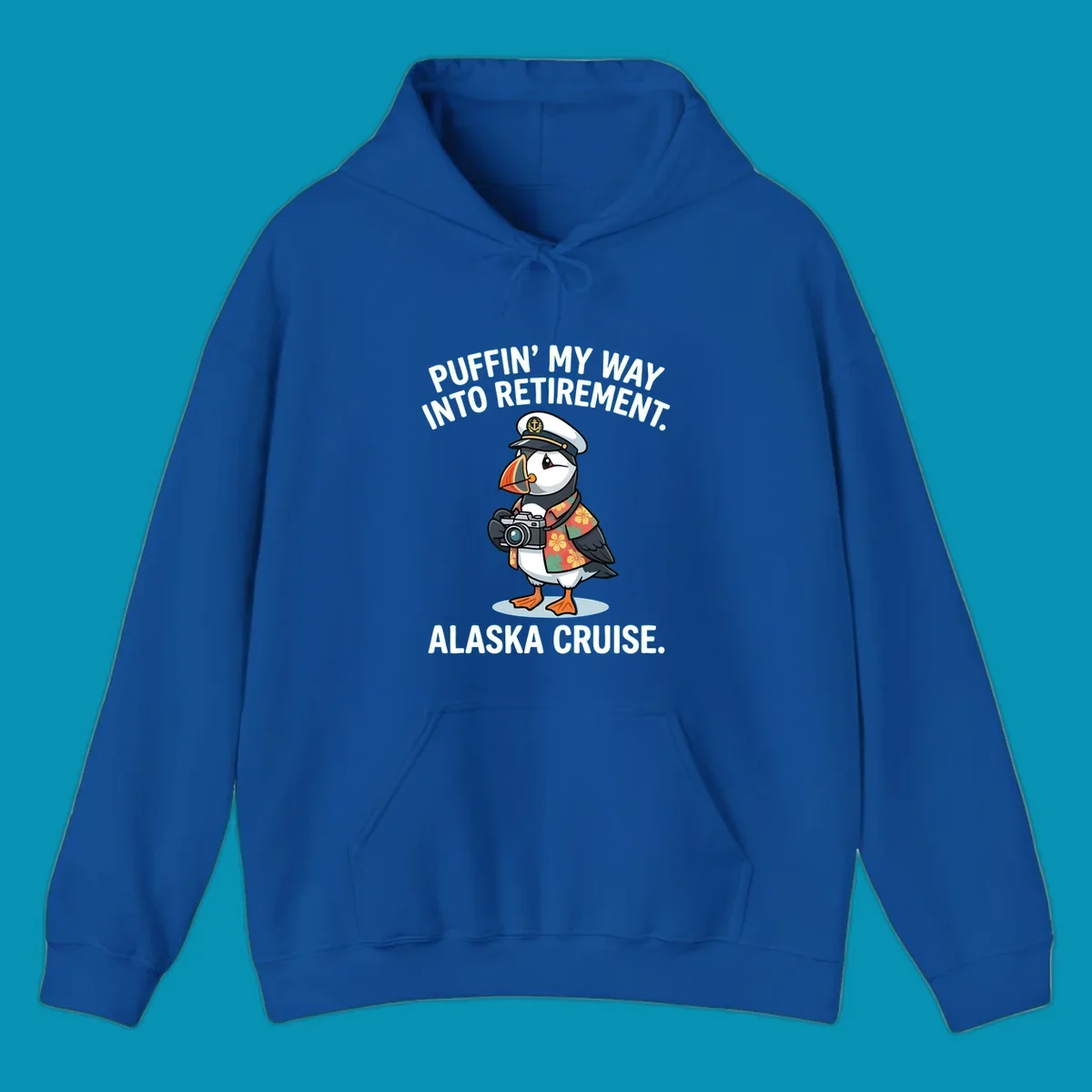 A cartoon puffin wearing a captain's hat and Hawaiian shirt holds a camera, with text 'PUFFIN' INTO MY RETIREMENT. ALASKA CRUISE.' for a puffin-into-retirement-cruise.