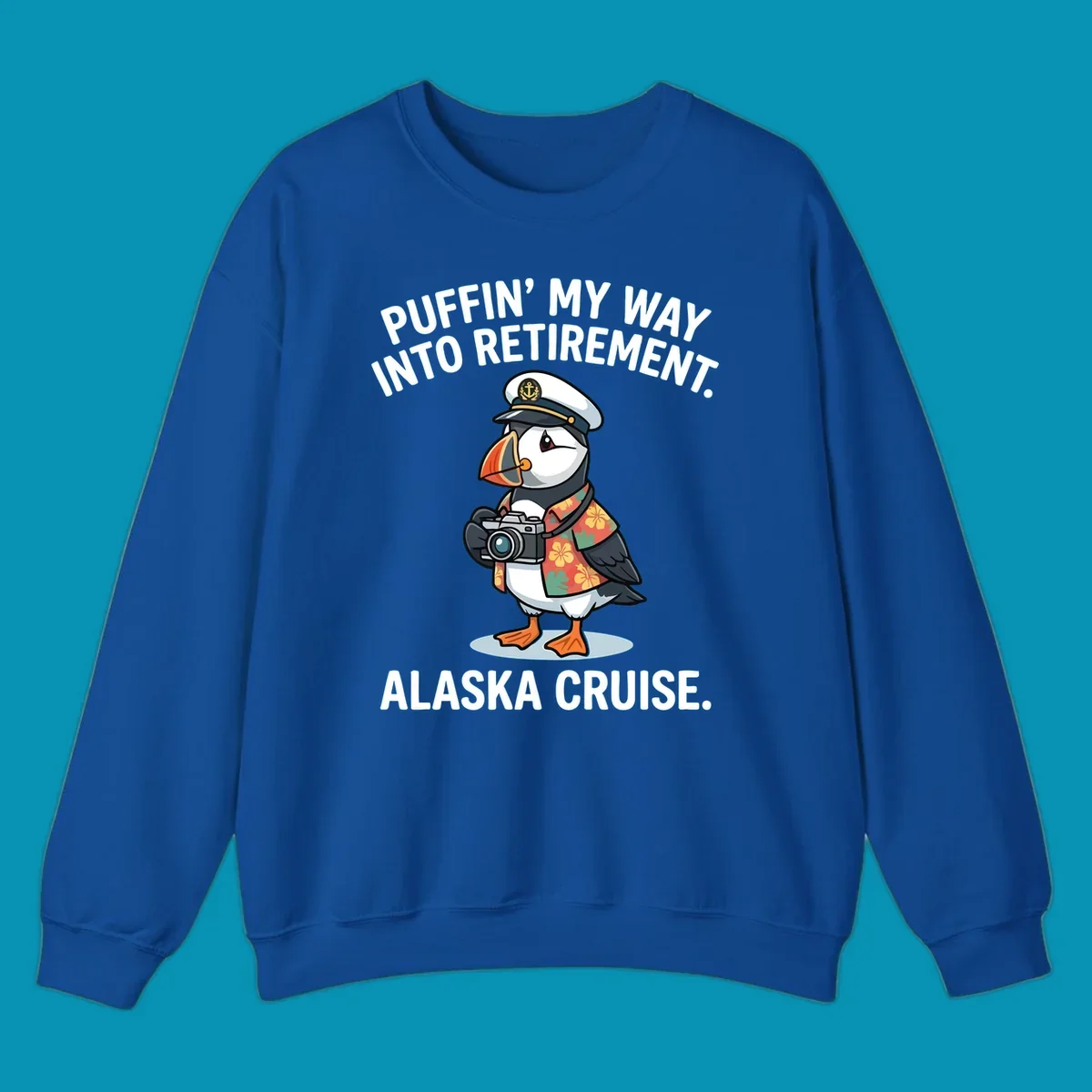 A cartoon puffin wearing a captain's hat and Hawaiian shirt holds a camera, with text 'PUFFIN' INTO MY RETIREMENT. ALASKA CRUISE.' for a puffin-into-retirement-cruise.