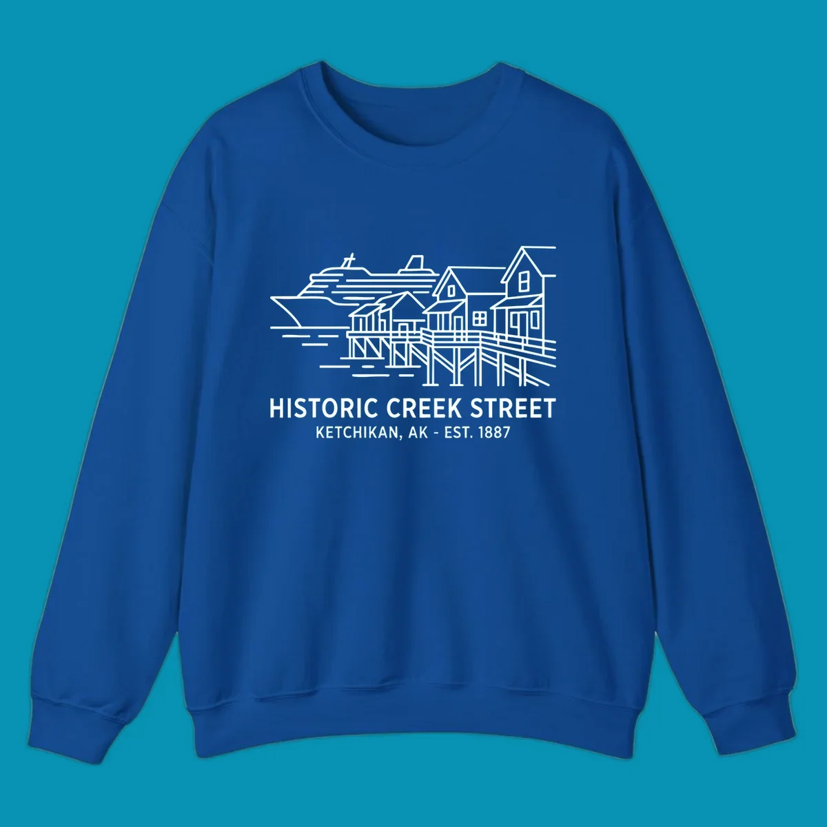 White line art illustration of Historic Creek Street in Ketchikan, Alaska, with a cruise ship, waterfront buildings, and text.
