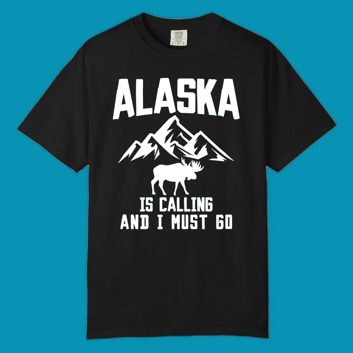 White moose silhouette and snow-capped mountains with text reading Alaska is calling and I must go
