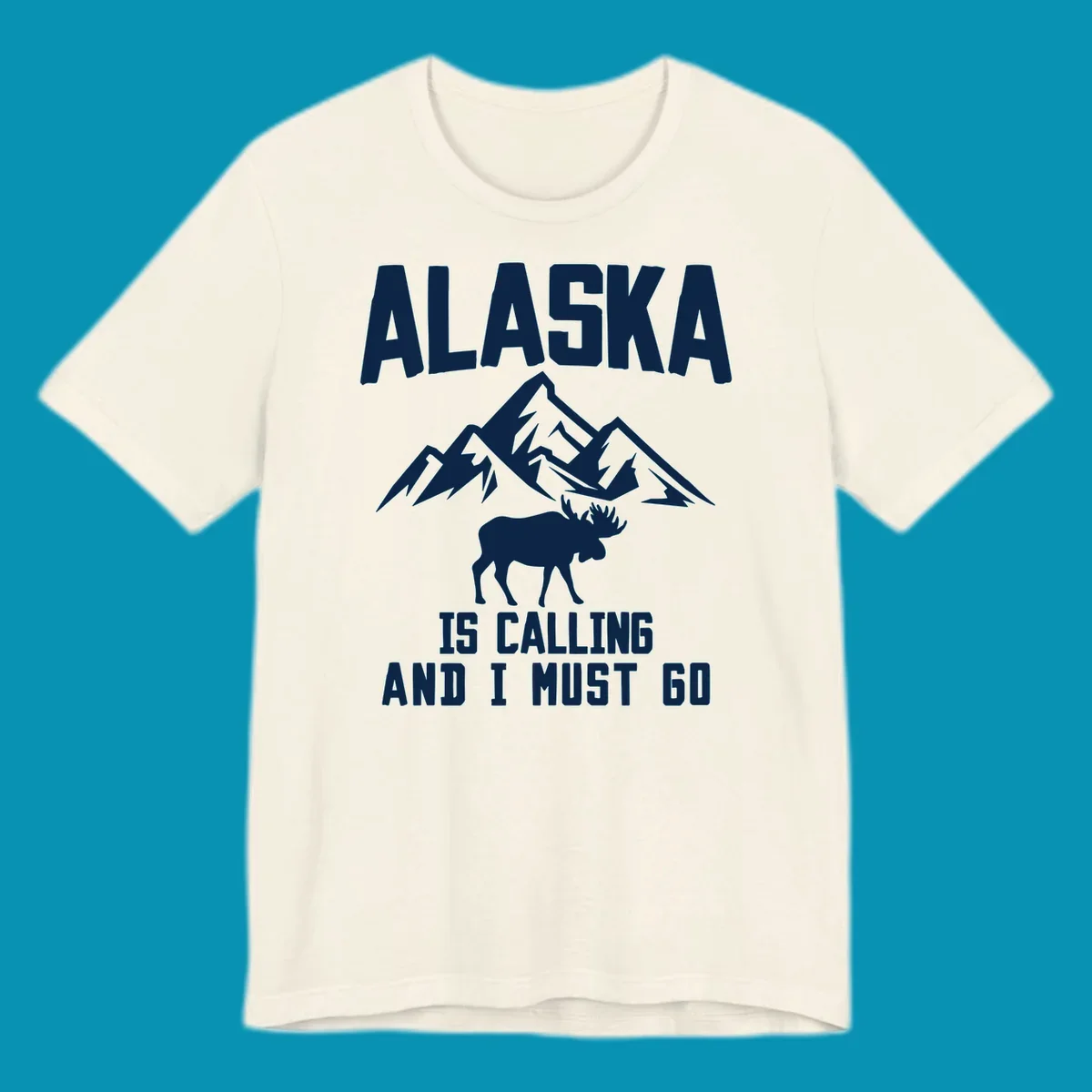 White moose silhouette and snow-capped mountains with text reading Alaska is calling and I must go