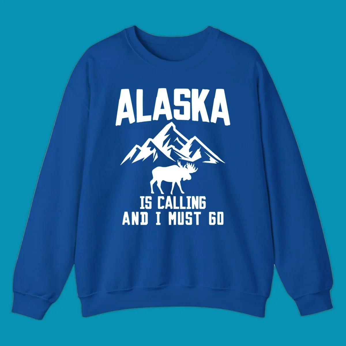 White moose silhouette and snow-capped mountains with text reading Alaska is calling and I must go