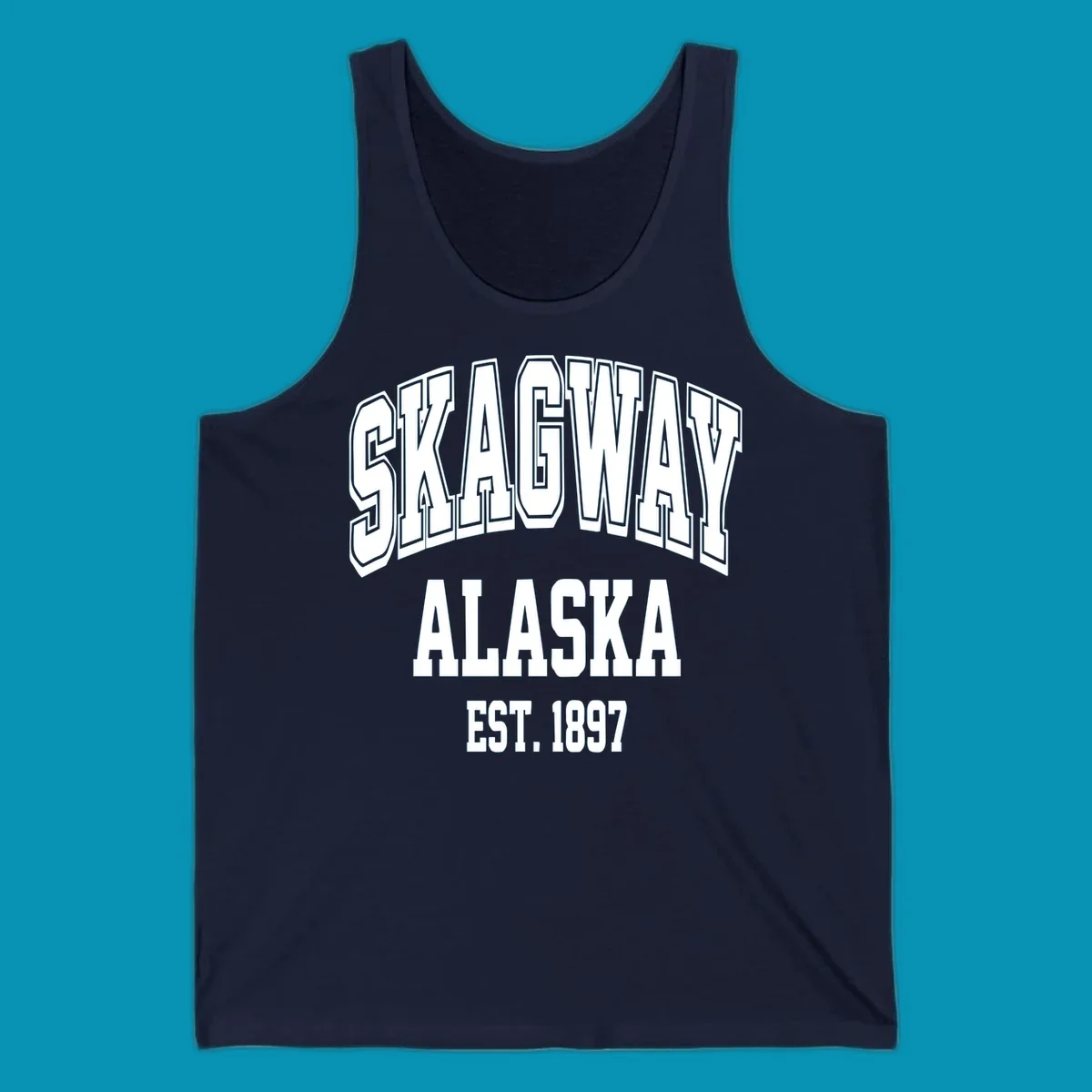 Vintage-style badge with bold outlined text reading Skagway Alaska Est. 1897 with decorative arrow accents on gray background.