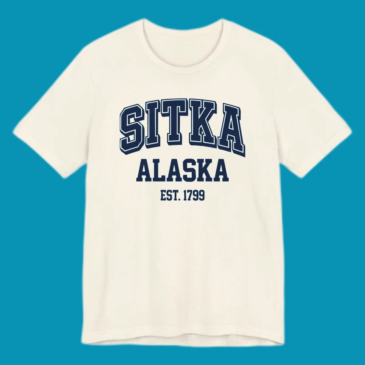 Vintage badge design reading Sitka Alaska Est. 1799 in bold outlined and solid white lettering on gray background
