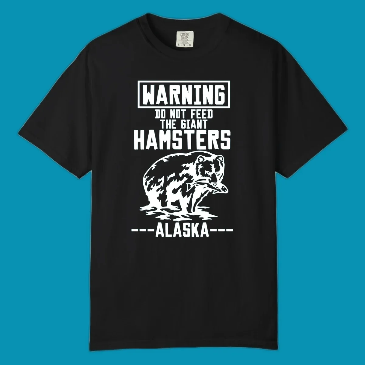 Warning-style design with giant hamster illustration and text reading 'Do Not Feed The Giant Hamsters Alaska' in white lettering on gray background