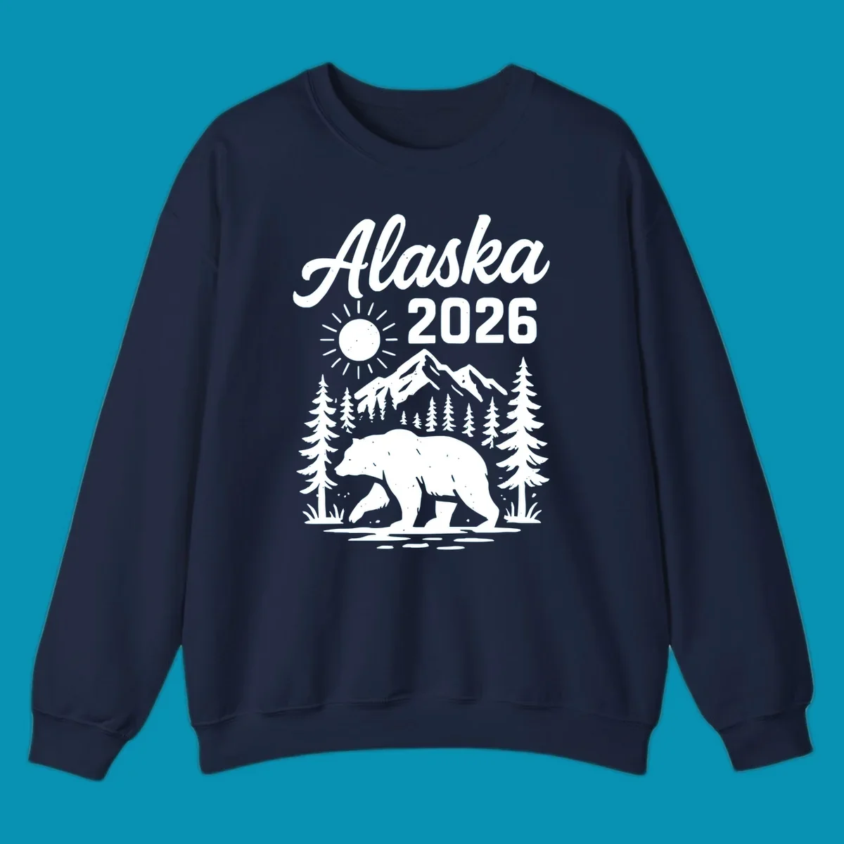 Alaska 2026 design featuring a polar bear walking through snowy mountains surrounded by evergreen trees and bright sun