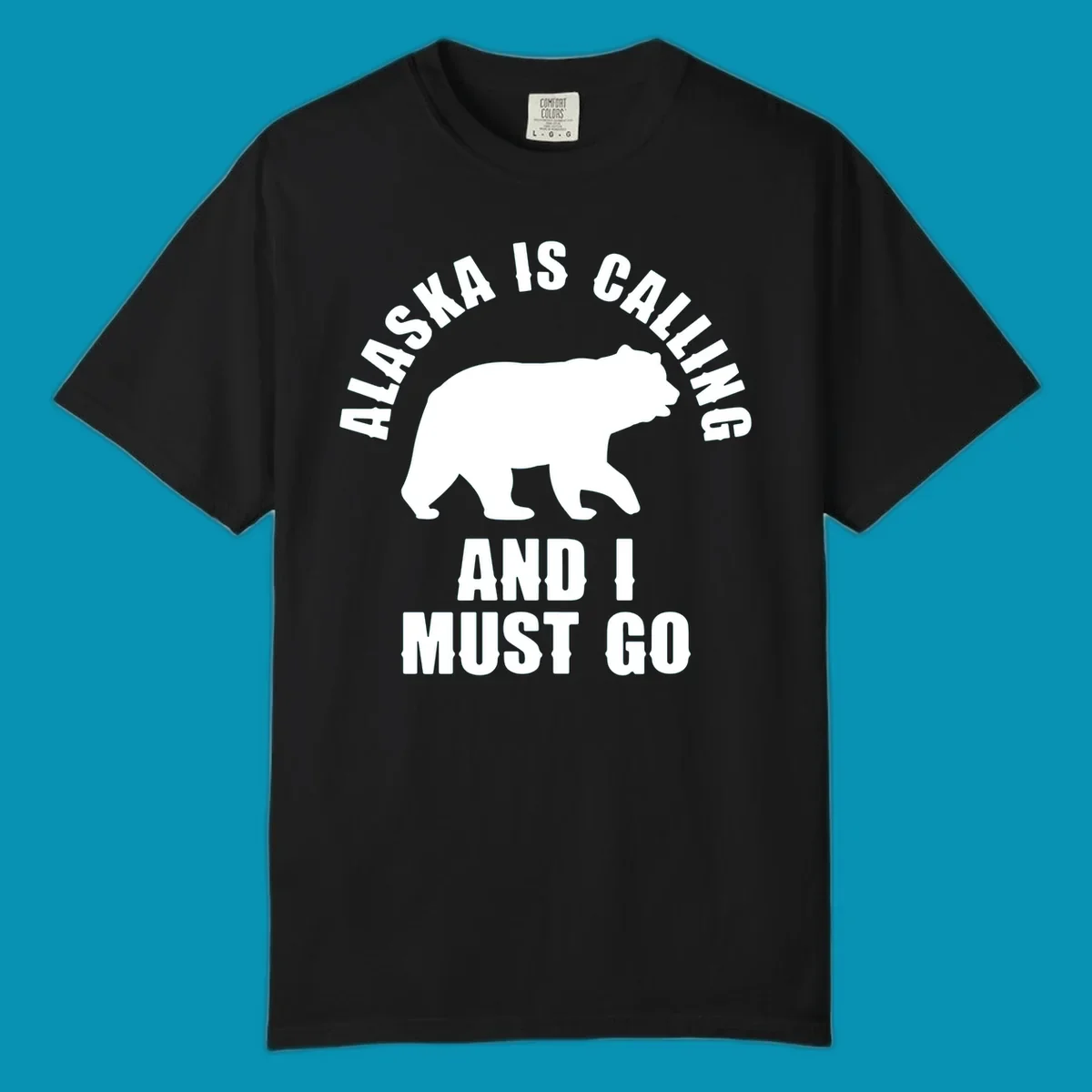 White bear silhouette with curved text reading 'Alaska is calling and I must go' on gray background