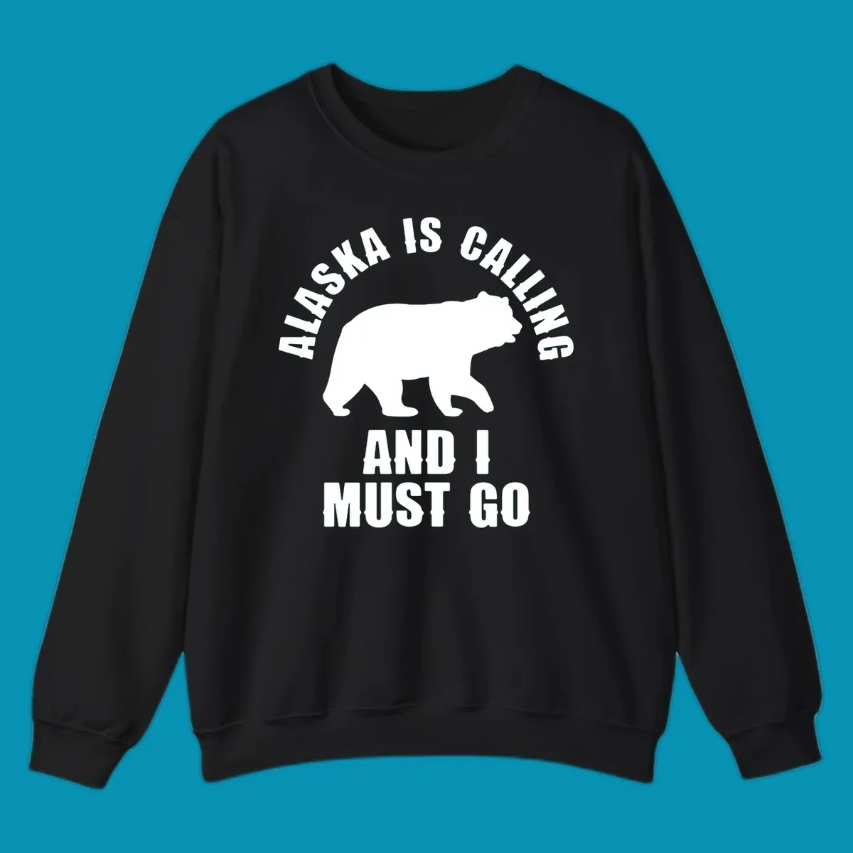 White bear silhouette with curved text reading 'Alaska is calling and I must go' on gray background
