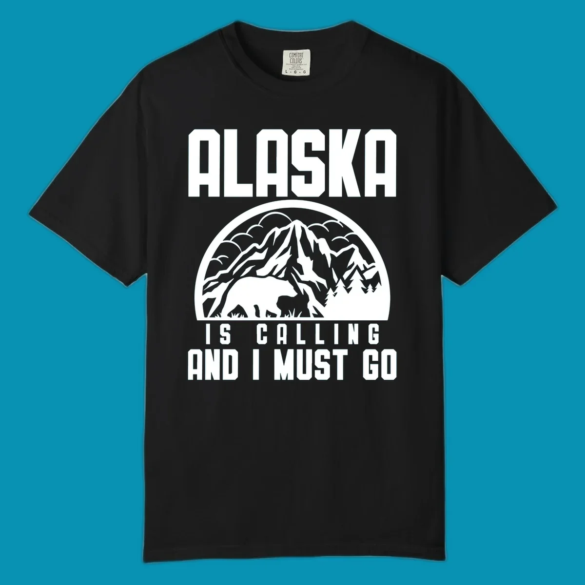 Vintage badge design with 'Alaska Is Calling And I Must Go' text, featuring mountain peak, bear, and evergreen trees