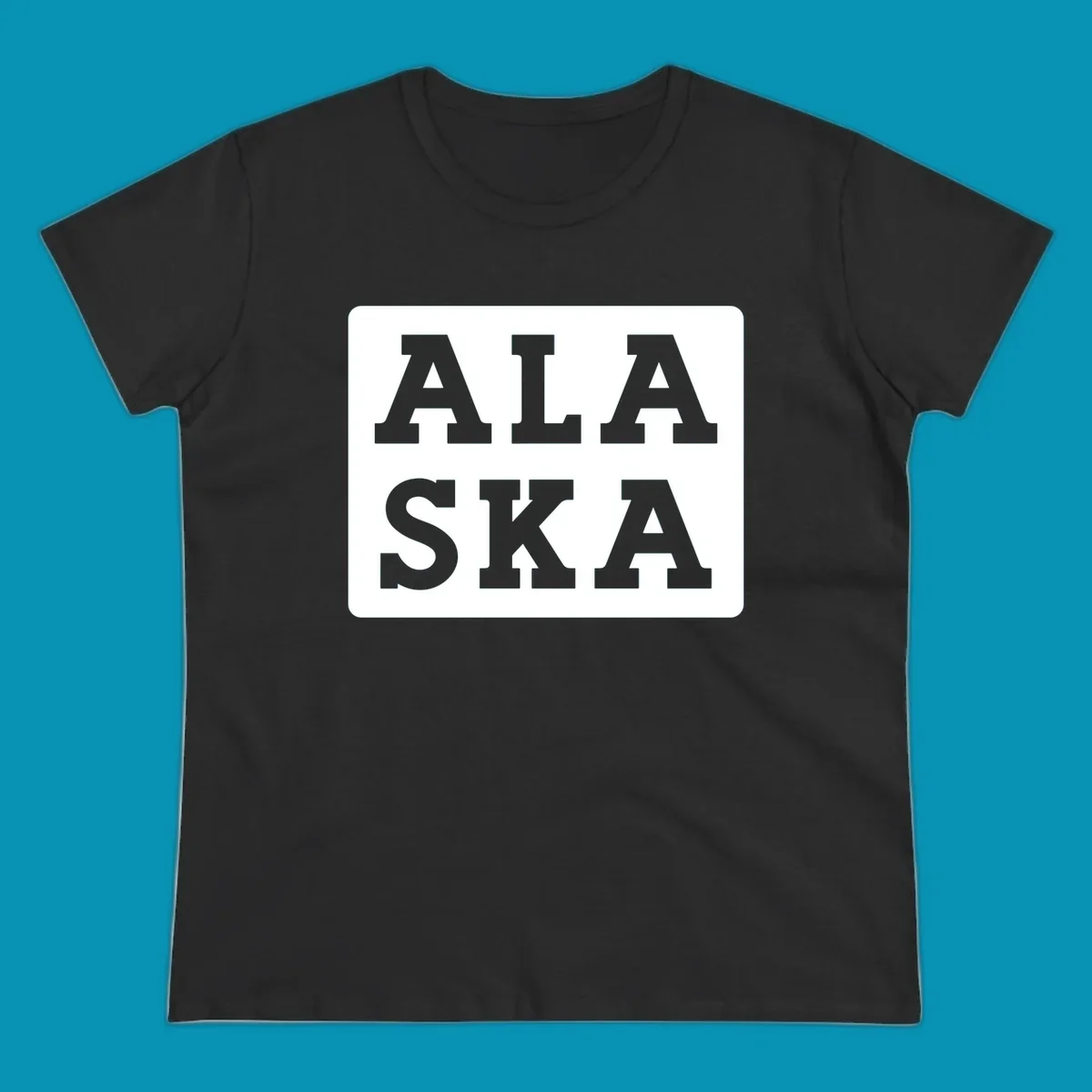 Bold gray block letters spelling 'ALA SKA' with geometric triangle cutouts, creating a playful Alaska pun design