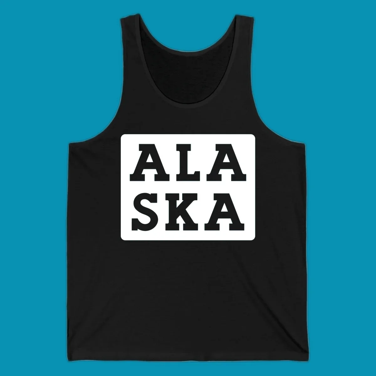 Bold gray block letters spelling 'ALA SKA' with geometric triangle cutouts, creating a playful Alaska pun design