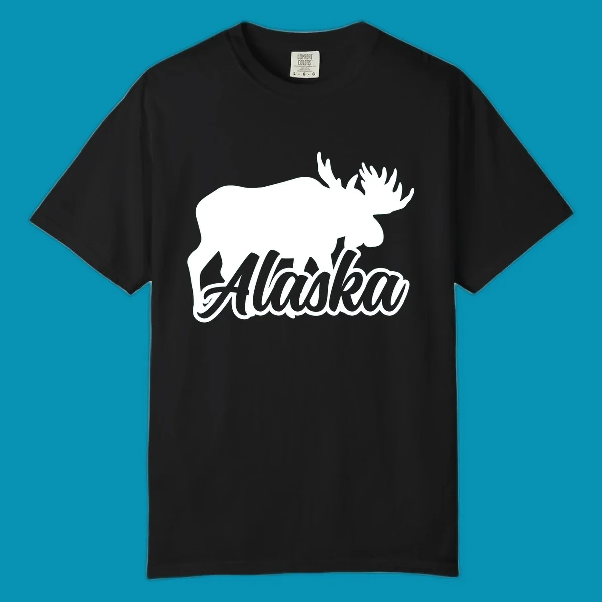 White moose silhouette with branching antlers above stylized 'Alaska' text in gray lettering on gray background