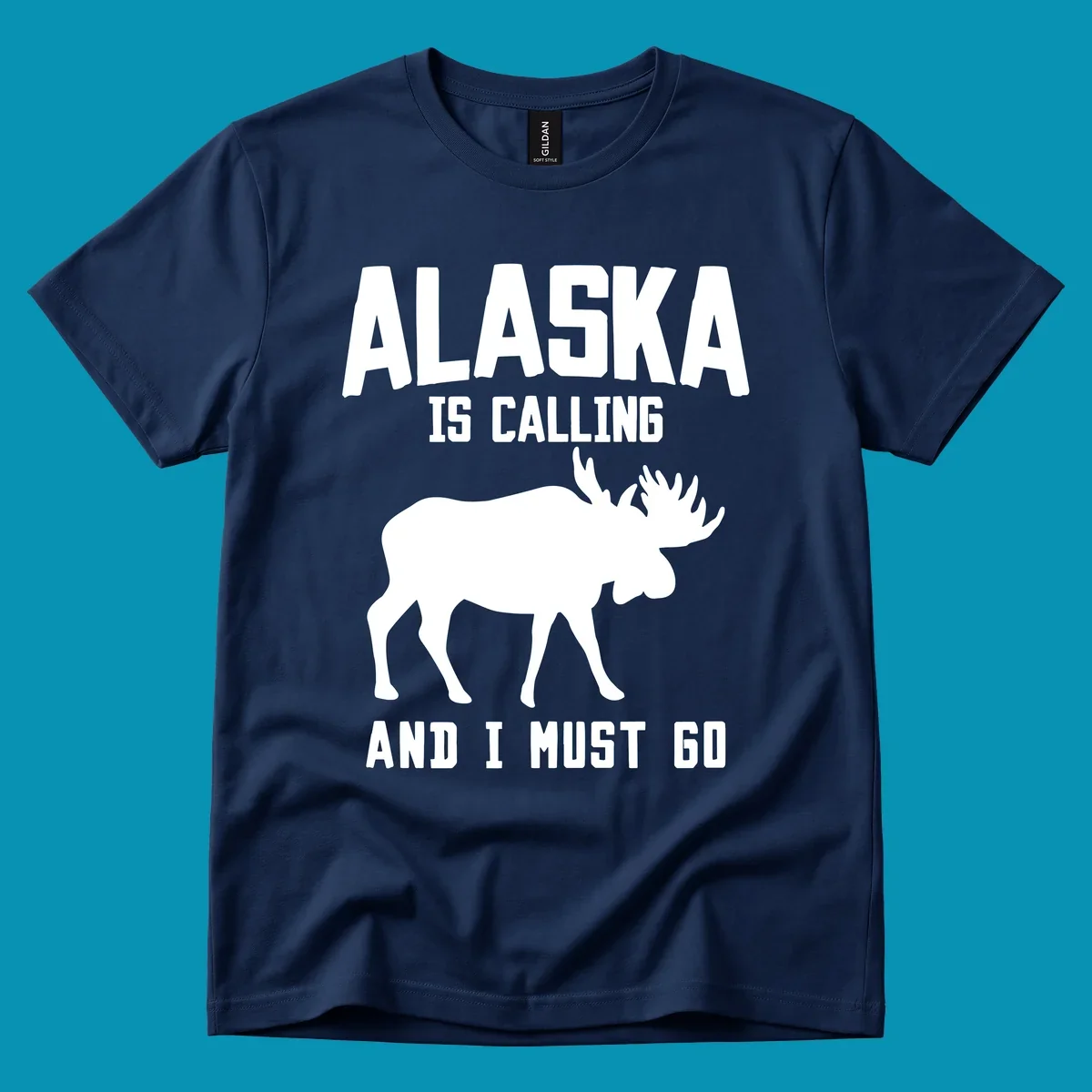 White moose silhouette with text 'Alaska Is Calling And I Must Go' on gray background—Alaska is calling moose design