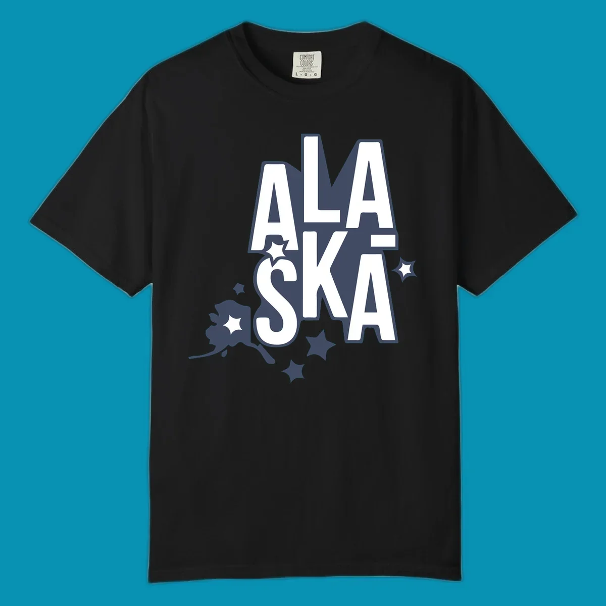 Alaska adventure lettering design with bold outlined text, decorative stars, and botanical accents in navy and white