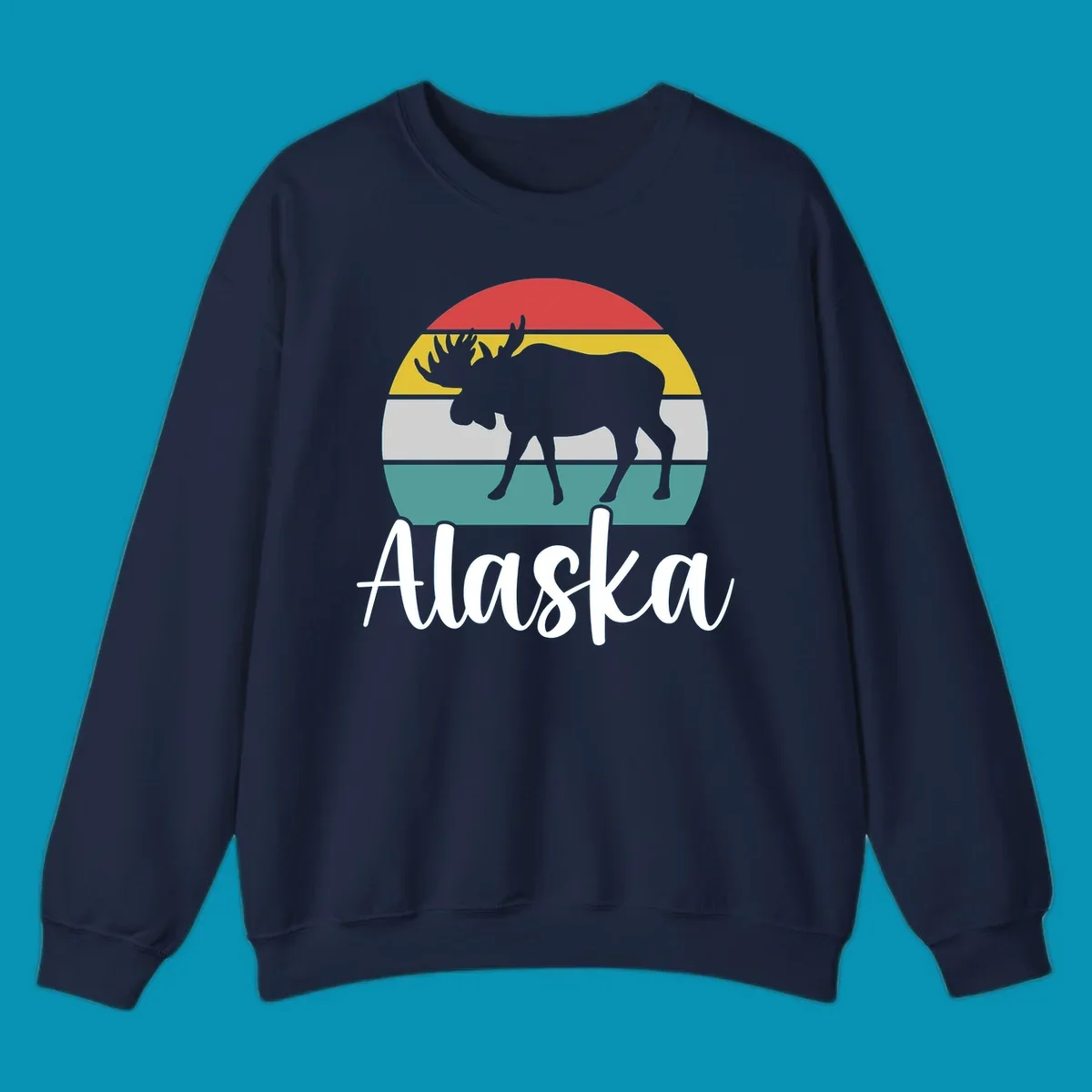 White moose silhouette against red, gold, gray, and teal horizontal stripes in a circular badge design representing Alaska mountains and wildlife.
