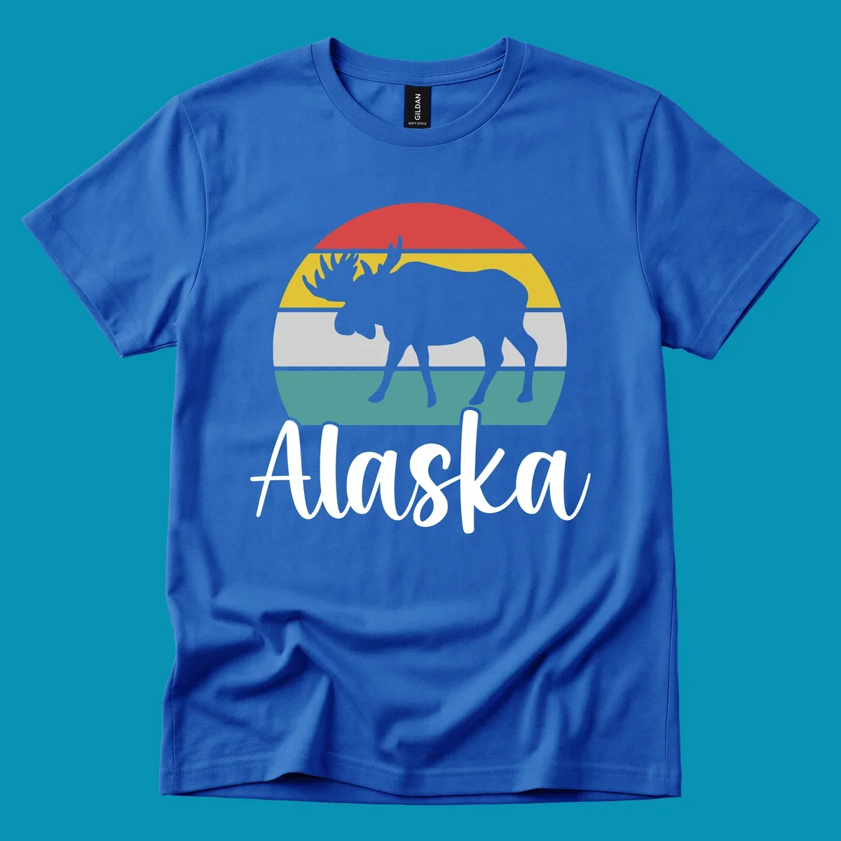 White moose silhouette against red, gold, gray, and teal horizontal stripes in a circular badge design representing Alaska mountains and wildlife.