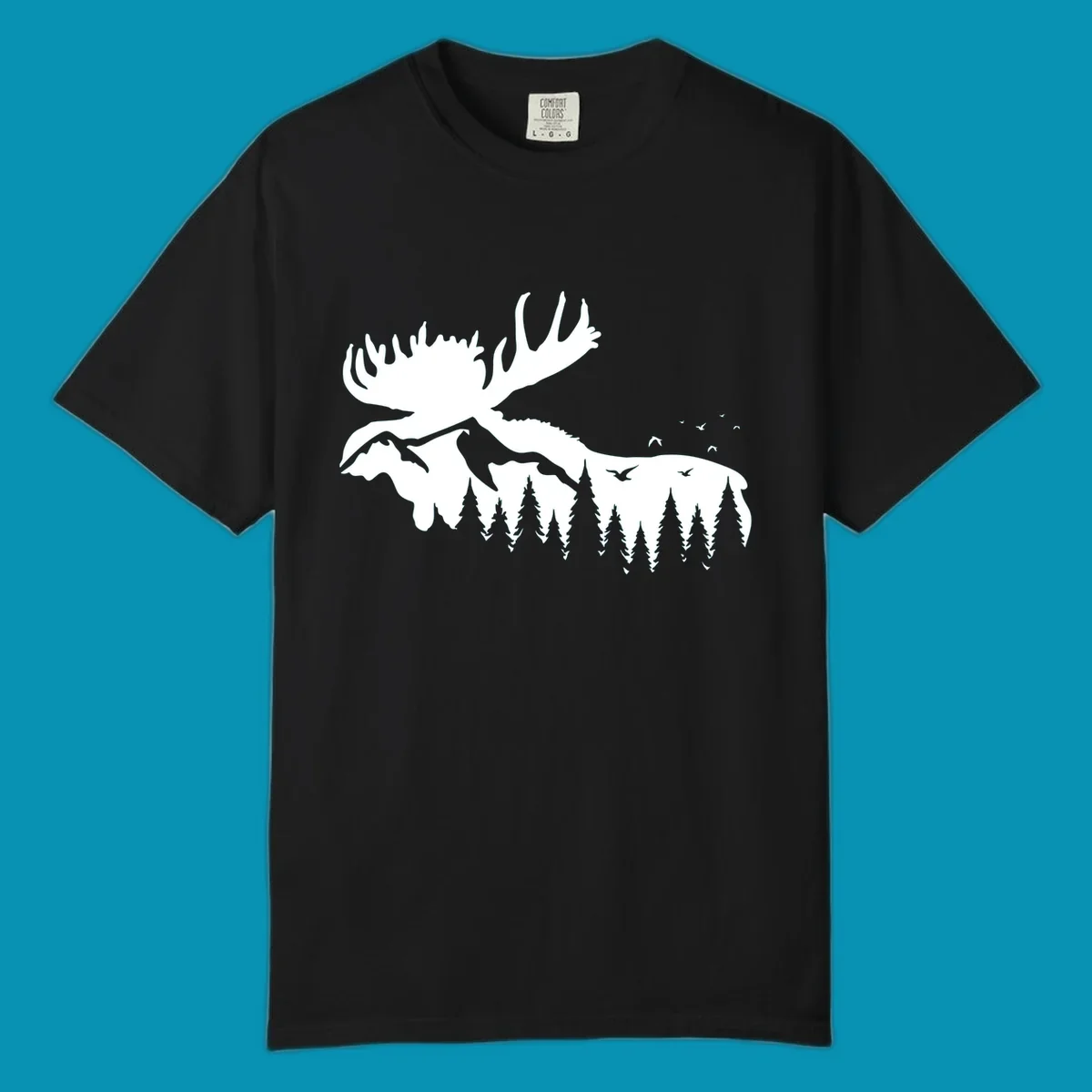 White silhouette of a moose with large antlers integrated into a forested mountain landscape with evergreen trees and flying birds against gray background.